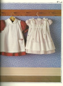 A red dress with a white pinafore - so cute!