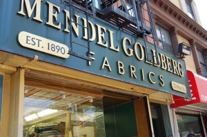 The distinctive sign for Mendel Goldberg Fabrics on Hector Street in NYC.