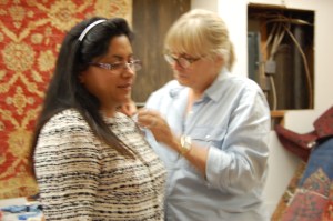 Susan fine-tunes the shoulders of Myra's jacket.