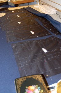 Here are the silk organza underlining pieces arranged on the blue fabric. I pinned a small tag on each piece, telling me each piece's pattern # and description. A lot of the pieces look alike!