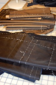 Two piles showing all underlinings basted onto the fashion fabric.