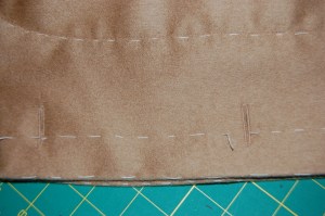 The buttonholes show up better on the camel wool. Click on the photo for a close-up.