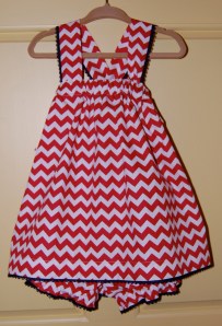 The shoulder straps twist through loops in the back and become the sash for the dress.