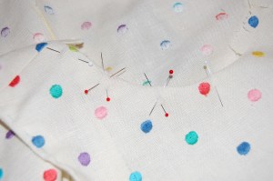 Perhaps you can see the shadowing of the dots underneath the crossed pins?