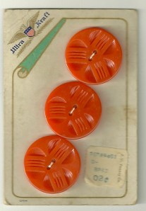 This card of buttons cost 2 cents originally!  They seem to mimic the small orange explosions on the dress fabric.