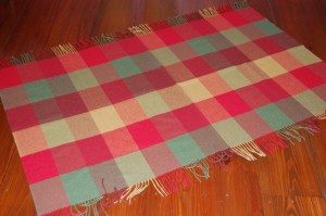 The dimensions of this small blanket are approximately 36" long by 62" wide.  The fringe is 3 1/2" long.