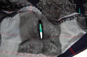 The silk organza patch is sewn onto the right side. After cutting and clipping the corners - carefully! - you turn the organza and you have a perfectly finished opening to back up to your bound buttonhole. then it is easy to sew the two sides together very neatly.