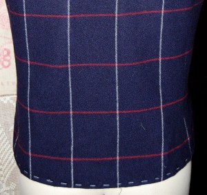 I always like to baste the hem along the bottom edge to stabilize it until the jacket is complete.