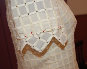 I decided the wider trim was necessary to make the proper impact. Here it is pinned onto one sleeve.
