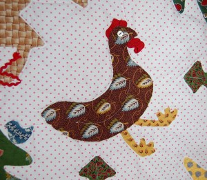 I embellished the chicken with wide rick rack. One of the fun aspects of designing a quilt is the ability to select the perfect fabric to tell your story - this hen has feathers!