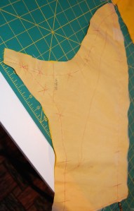 Here is that sleeve piece in the fashion fabric, with silk organza underlining basted to it.