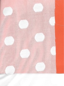 I backed this fabric with a piece of orange paper so that the polka dot design shows. The dots are woven into this fine cotton from Britex Fabrics.